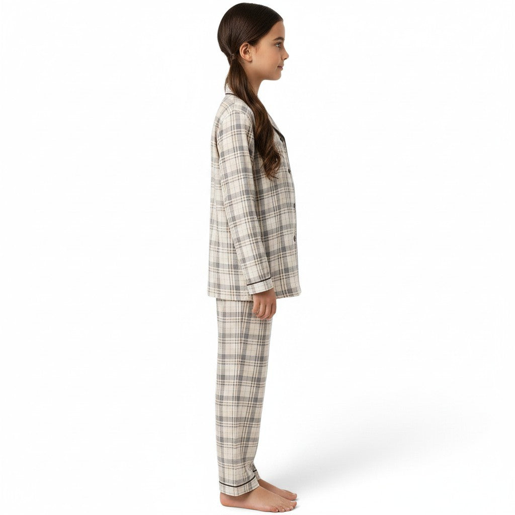 JOANNA FASHION girls' neutral plaid button-down pajama set with long sleeves and pants, side view on a young girl.
