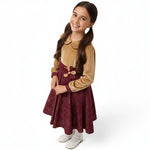JOANNA FASHION girls' long sleeve velvet dress with a gold bodice, maroon patterned skirt, and floral waist accent.