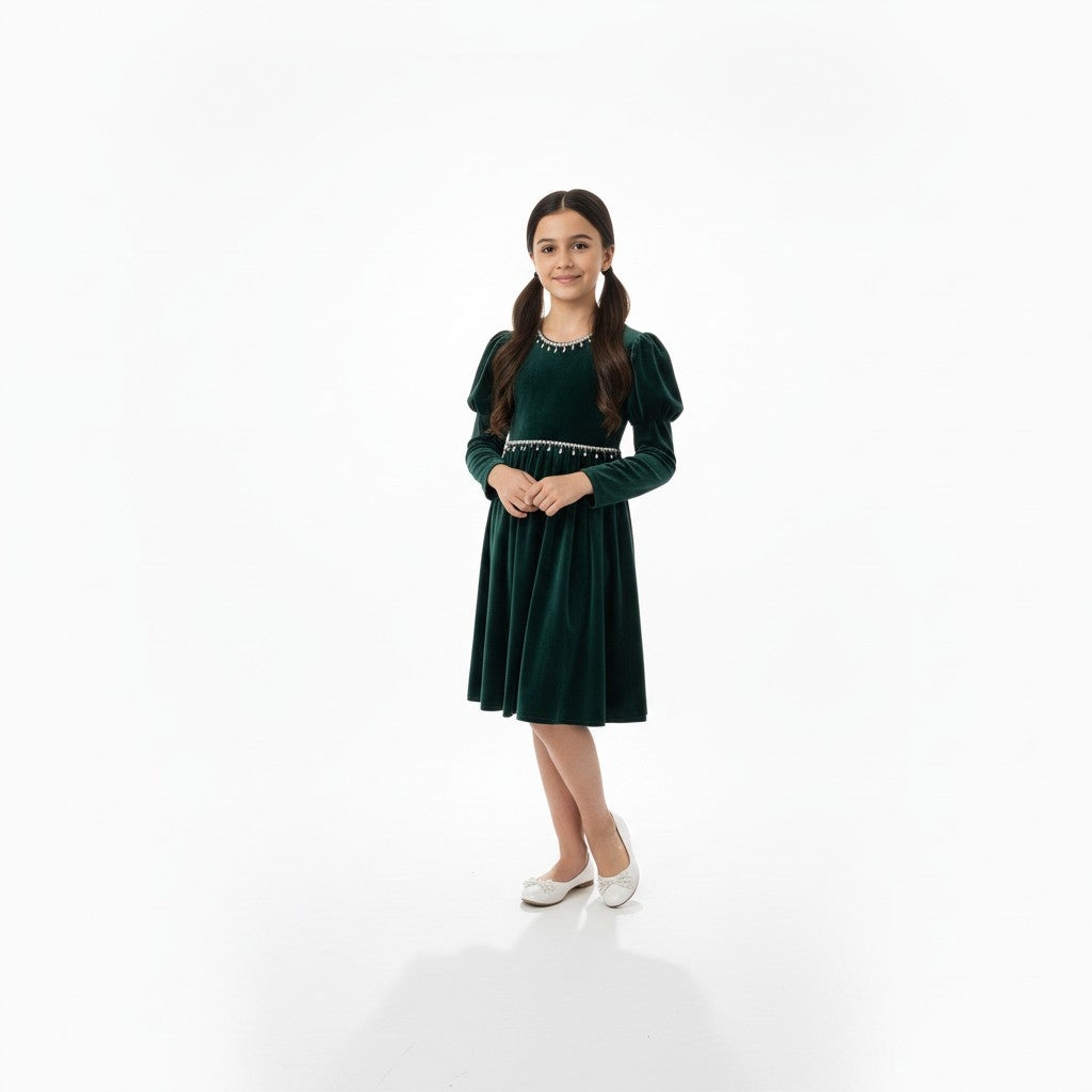 JOANNA FASHION girl wearing a dark green velvet dress with puff sleeves and pearl trim, standing on a white background.