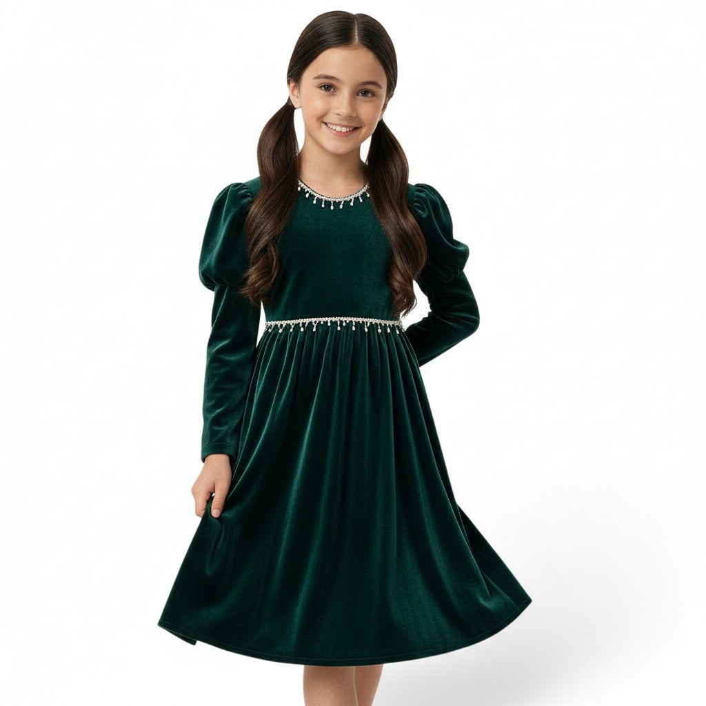 JOANNA FASHION girl wearing a dark green velvet dress with puff sleeves and pearl-style trim at the neckline and waist