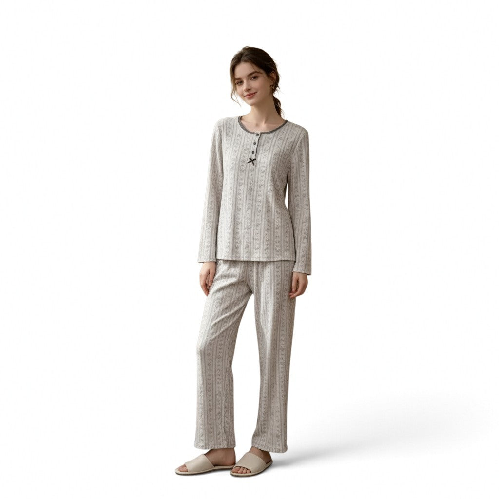 A woman wearing a JOANNA FASHION long sleeve pajama set in a light grey vertical stripe pattern with button detail.