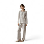 A woman wearing a JOANNA FASHION long sleeve pajama set in a light grey vertical stripe pattern with button detail.