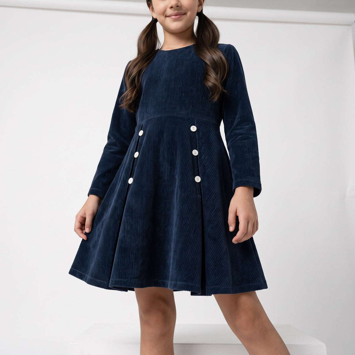 JOANNA FASHION girls navy blue long sleeve corduroy dress with white button details and a drop-waist silhouette