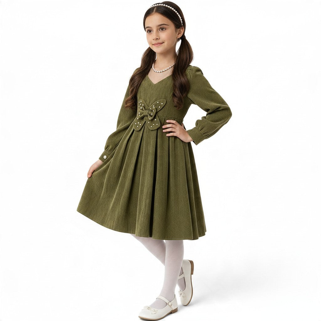 JOANNA FASHION olive green corduroy long sleeve dress with a pearl-embellished butterfly waist detail on a young girl.