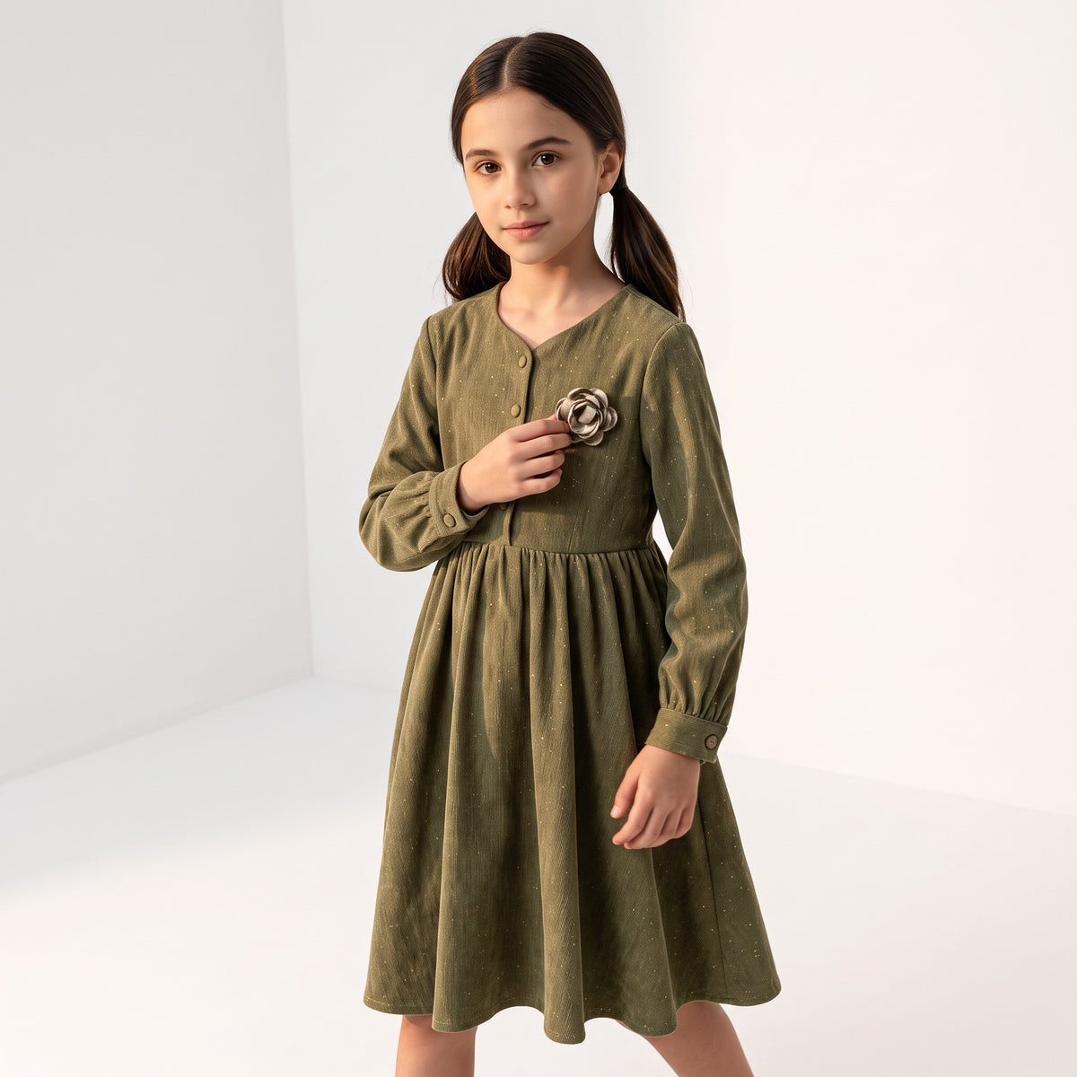 JOANNA FASHION olive green corduroy long sleeve dress with a floral appliqué on the chest worn by a young girl