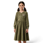 JOANNA FASHION olive green corduroy long sleeve dress with a floral appliqué on the chest worn by a young girl