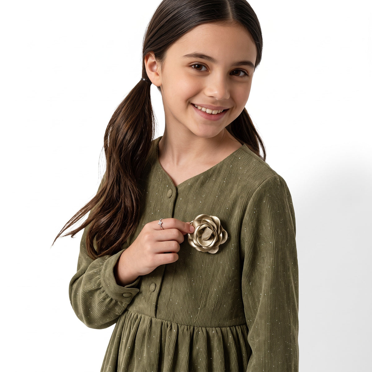JOANNA FASHION girl wearing an olive green long sleeve corduroy dress with a gold rose floral appliqué on the chest