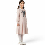 JOANNA FASHION girl wearing a pale pink textured long-sleeve dress with a Peter Pan collar and grey bow detail.