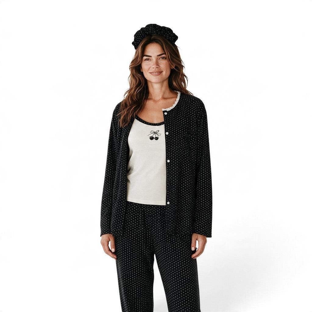 Model wearing a JOANNA FASHION three-piece black polka dot pajama set with a cherry tank top and matching headband.