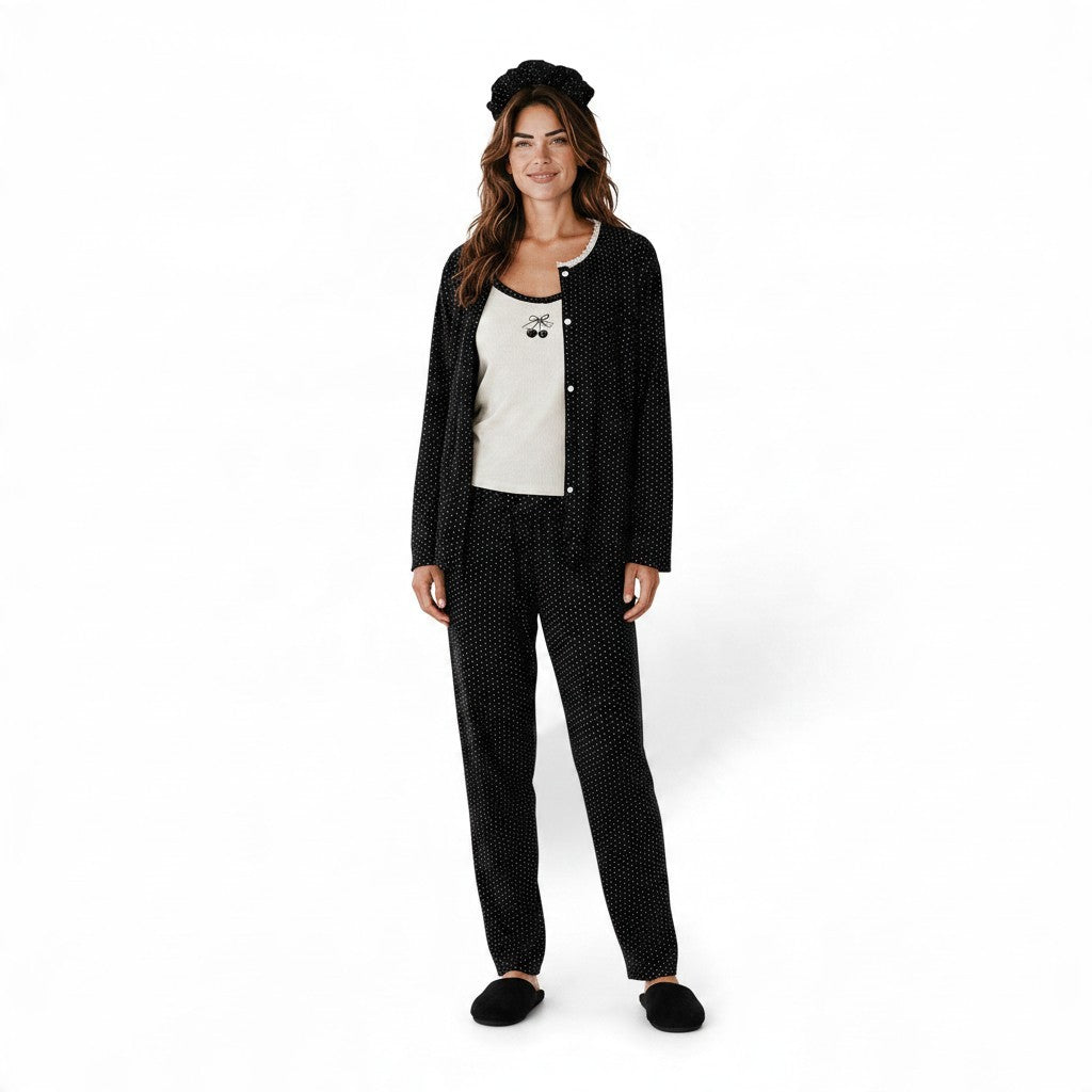 Model wearing JOANNA FASHION black polka dot three-piece pajama set with cherry motif tank and matching headband