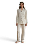Model wearing a JOANNA FASHION long-sleeve button-down pajama set in cream with a delicate black speckled print.