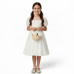 JOANNA FASHION white flower girl dress with floral applique bodice, puff sleeves, and rhinestone belt on a young girl