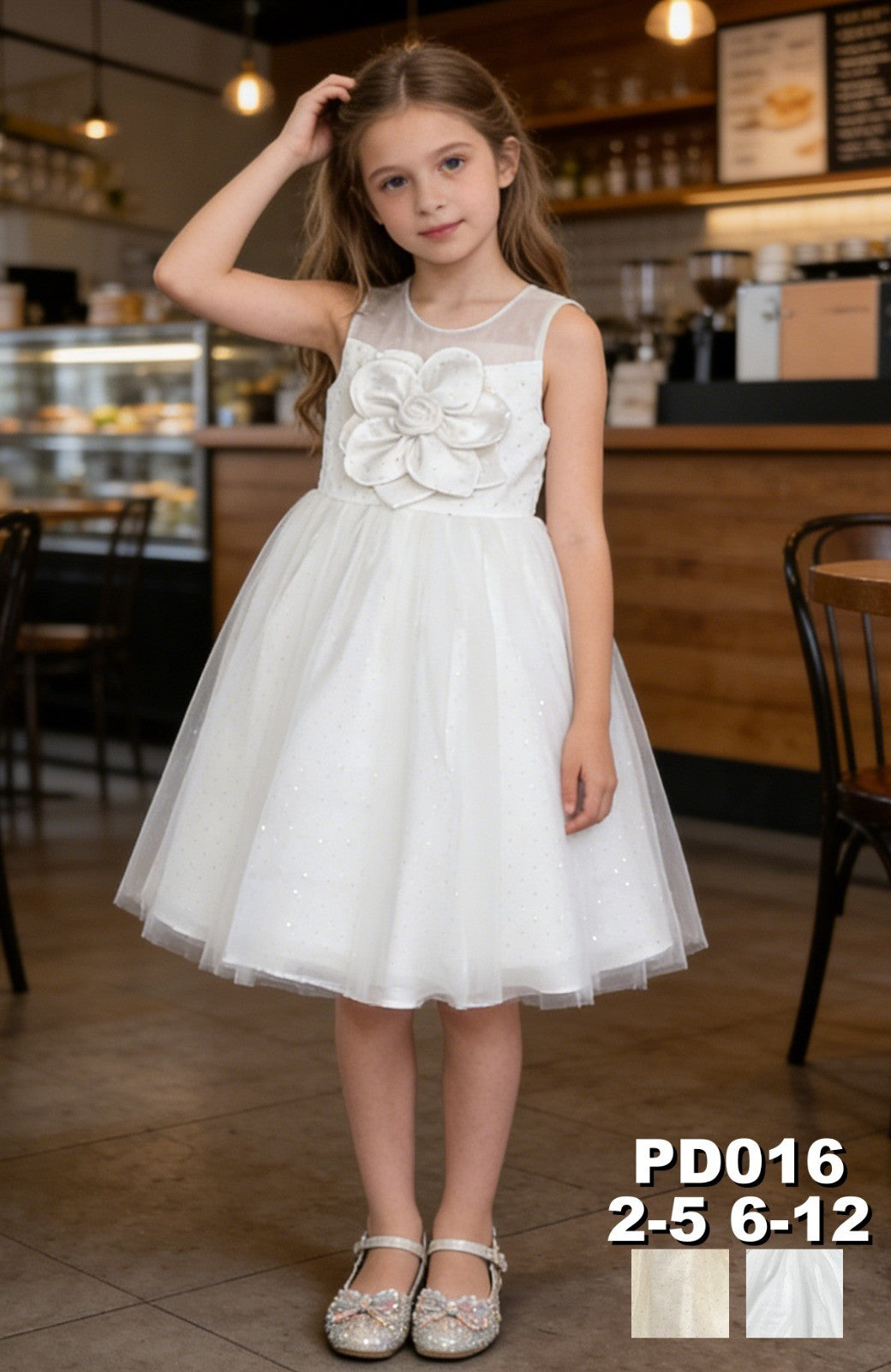 JOANNA FASHION white flower girl dress with sheer neckline, oversized floral applique, and shimmering tulle skirt.